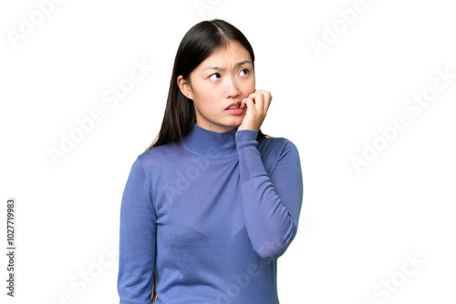 Young Asian woman over isolated chroma key background is a little bit nervous