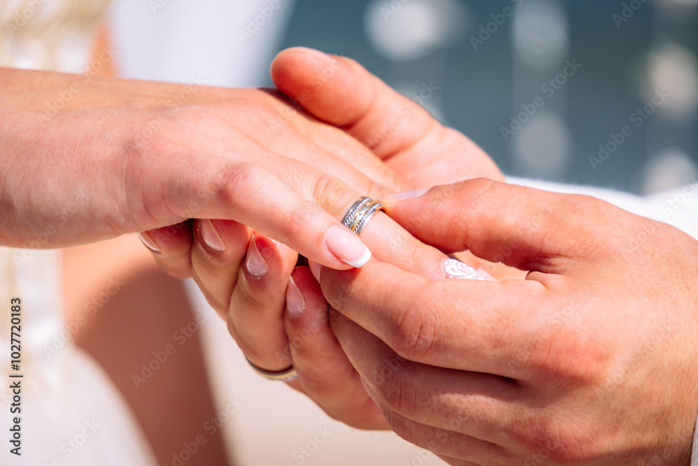 Bride is holding in her arm golden wedding ring on the caribbean seashore in summer sunny day Bride is holding in her arm golden wedding ring on the caribbean seashore in summer sunny day
