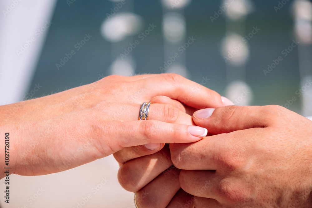 Bride is holding in her arm golden wedding ring on the caribbean seashore in summer sunny day Bride is holding in her arm golden wedding ring on the caribbean seashore in summer sunny day