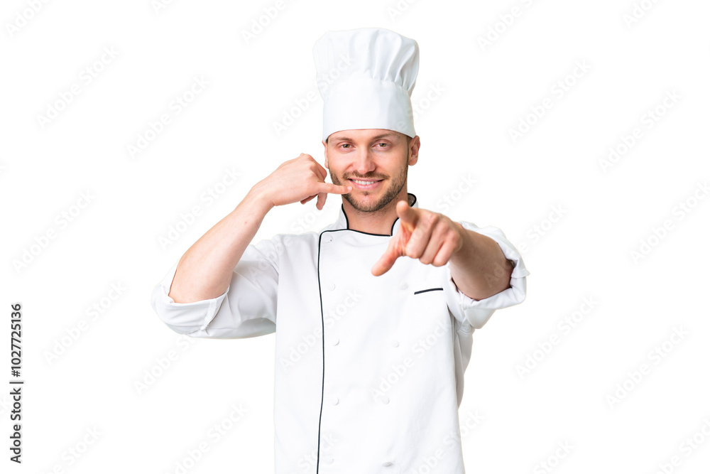 Young caucasian chef over isolated chroma key background making phone gesture and pointing front Young caucasian chef over isolated chroma key background making phone gesture and pointing front