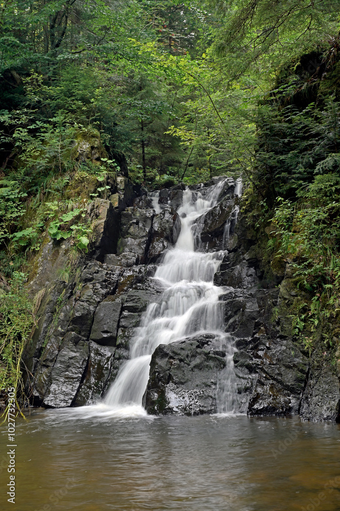 Small picturesque waterfall in a mountain forest gorge in the Ukrainian Carpathians. Small picturesque waterfall in a mountain forest gorge in the Ukrainian Carpathians.