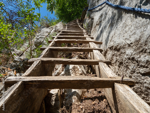 Wooden stairs on the trail to Inelet and Scarisoara hamlets, Romania photo