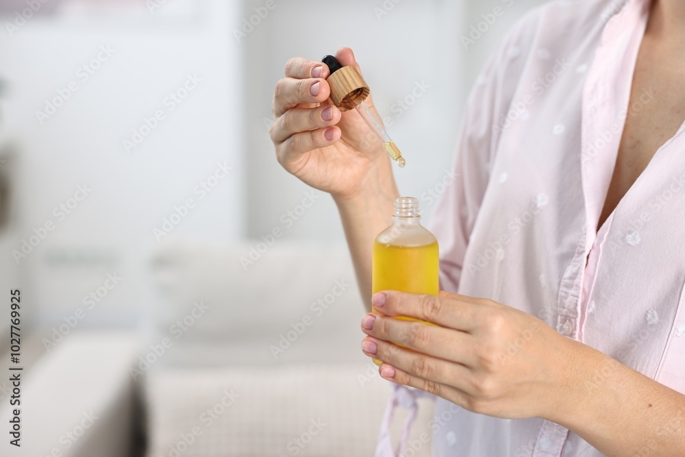 Young woman taking CBD tincture indoors, closeup. Space for text Young woman taking CBD tincture indoors, closeup. Space for text