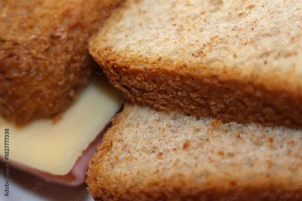 slices of bread with cheese and ham. background of bread with ham and cheese. food details. slices of bread with cheese and ham. background of bread with ham and cheese. food details.