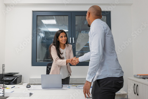 Female hiring manager accepting a job candidate in the office and conducting a recruitment meeting. Labor and employment concepts