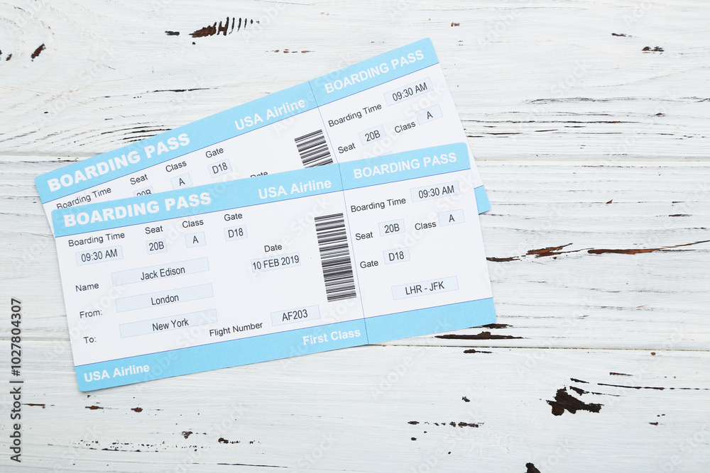 Airline boarding passes on white wooden background