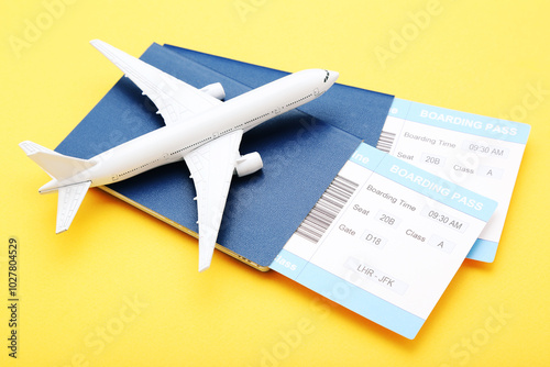 Obraz na płótnie Passports with boarding passes and airplane model on yellow background w salonie