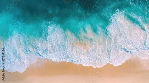 High-altitude view of crystal-clear sea with gentle waves and a bright sandy beach under the sun