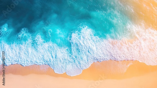 High-altitude view of turquoise water with bright sunlight on the waves and a golden beach below