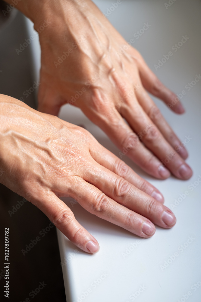 Beautiful hands of mature 50s middle aged woman. Small wrinkles and swollen veins are visible. Beautiful natural manicure. Beautiful hands of mature 50s middle aged woman. Small wrinkles and swollen veins are visible. Beautiful natural manicure.