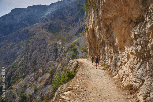 the trail next to the cliff with a family