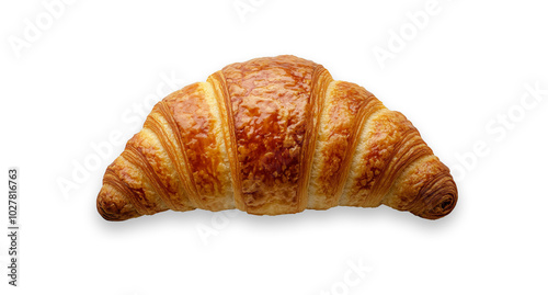 Freshly baked buttery croissant resting on a smooth surface in morning light