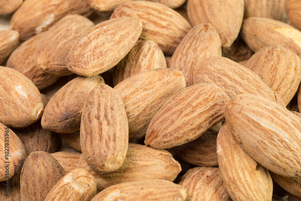 A close up of almonds with a brownish color A close up of almonds with a brownish color