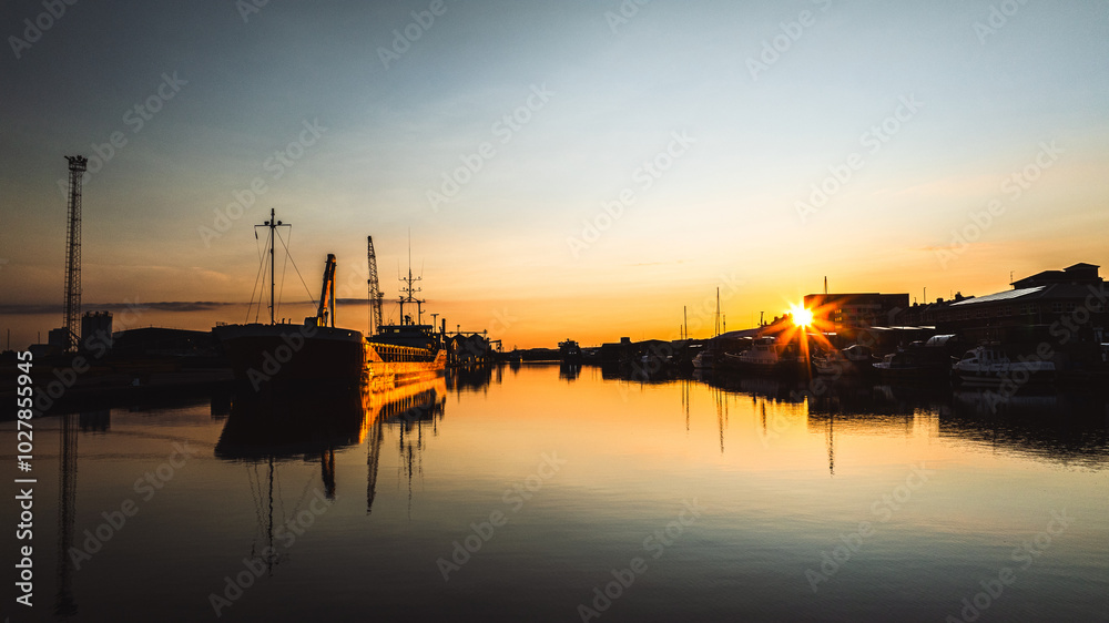 Calm and quiet shipyard with water reflections on a sunset, Brighton and Hove, East Sussex, UK Calm and quiet shipyard with water reflections on a sunset, Brighton and Hove, East Sussex, UK