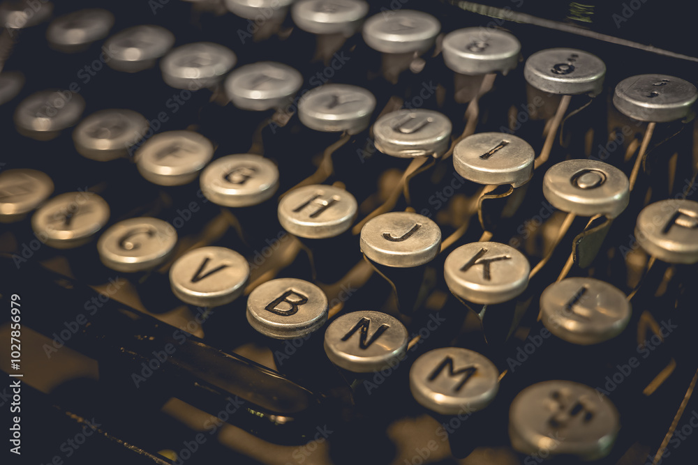 A close-up of the keys on an old typewriter, showing the letters G, H, J, K, L, V, B, N, M, and O A close-up of the keys on an old typewriter, showing the letters G, H, J, K, L, V, B, N, M, and O