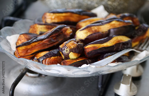 Eggplants cooked in oil were left to cool before placing them in the deep freezer photo