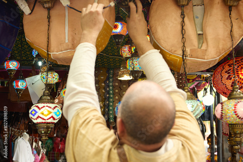 Man Arranging Colorful Mosaic Lamps in Turkish Bazaar