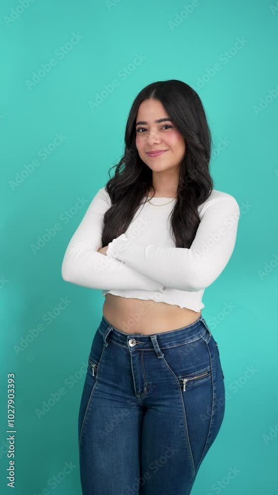 Portrait of smiling latina woman with arms crossed in a studio Portrait of smiling latina woman with arms crossed in a studio