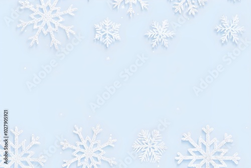 Frame of white snowflakes on light blue background. Christmas and New Year holiday concept. Winter season. Design for greeting card, invitation, banner with copy space. Flatlay, top view