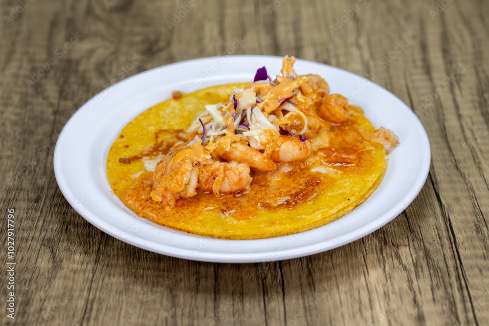 Grilled shirmp taco covered with encabronado sauce, cabbage, and cheese served on a tortilla for lunch Grilled shirmp taco covered with encabronado sauce, cabbage, and cheese served on a tortilla for lunch