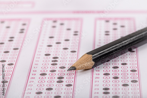 Exam, a hand taking an exam with a pen on an optical reader. Exam, an idea concept. Anxiety about the future, uncertainty. Multiple choice exam. Adults taking an exam. photo