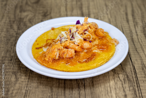 Grilled shirmp taco covered with encabronado sauce, cabbage, and cheese served on a tortilla for lunch