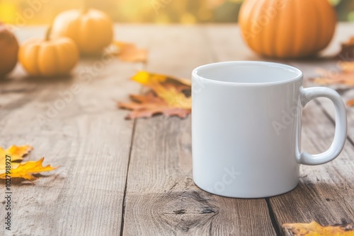 A cozy autumn setting with a blank mug surrounded by colorful leaves and pumpkins on a rustic wooden table in October