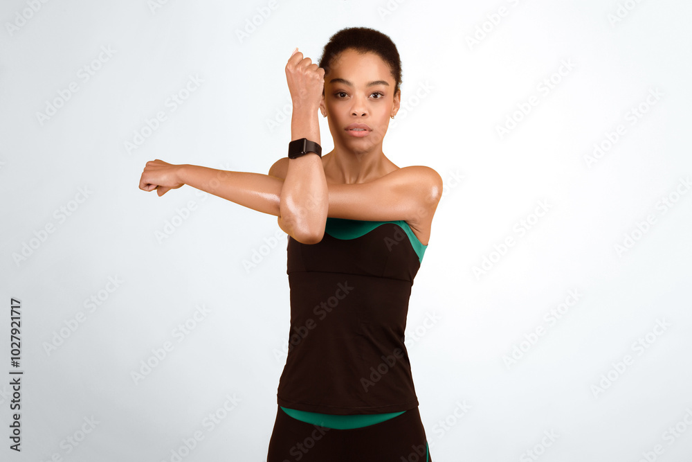 Fitness And Workout. Afro Woman Exercising Stretching Deltoid Arm Muscle Posing Over Yellow Studio Background Fitness And Workout. Afro Woman Exercising Stretching Deltoid Arm Muscle Posing Over Yellow Studio Background