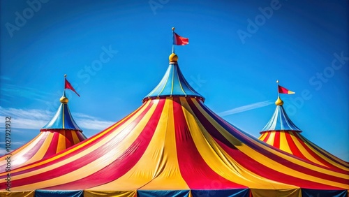 Vibrant and Colorful Circus Tent Roof Against a Clear Blue Sky for Fun and Entertainment themed stock photo