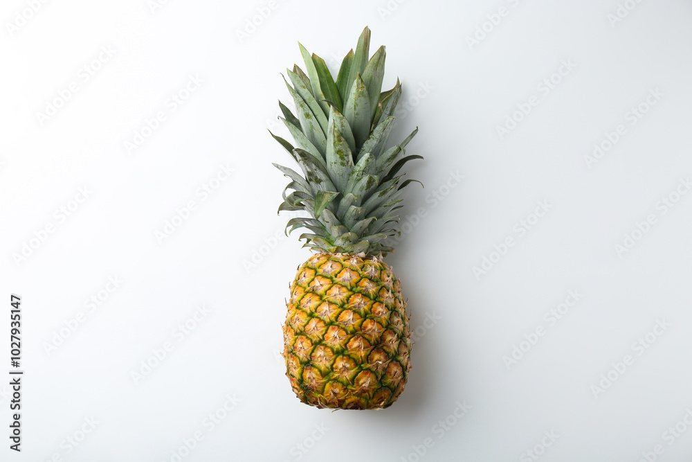 One fresh ripe pineapple on white background, top view One fresh ripe pineapple on white background, top view