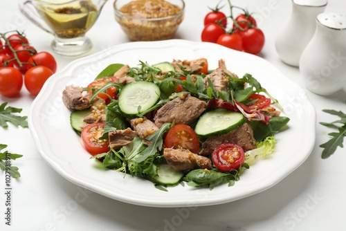 Delicious fresh tuna salad on white table, closeup