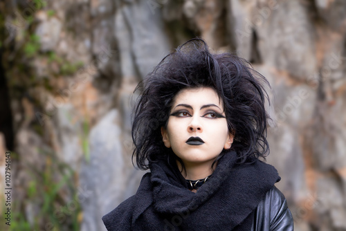 Portrait of Dark gothic fashion youg woman with black makeup, black lipstick and nose piercing. Italian beautiful brunette girl. Dark lady. Dark girl. Trad goth girl. Close-up photo