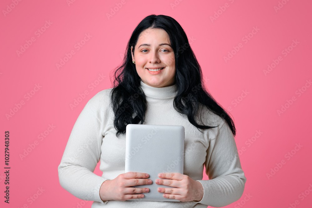 Smiling Plus Size Girl Posing With Digital Tablet In Hands, Standing Over Pink Background With Free space Smiling Plus Size Girl Posing With Digital Tablet In Hands, Standing Over Pink Background With Free space