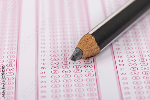 Exam, a hand taking an exam with a pen on an optical reader. Exam, an idea concept. Anxiety about the future, uncertainty. Multiple choice exam. Adults taking an exam. photo