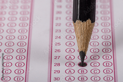 Exam, a hand taking an exam with a pen on an optical reader. Exam, an idea concept. Anxiety about the future, uncertainty. Multiple choice exam. Adults taking an exam. photo