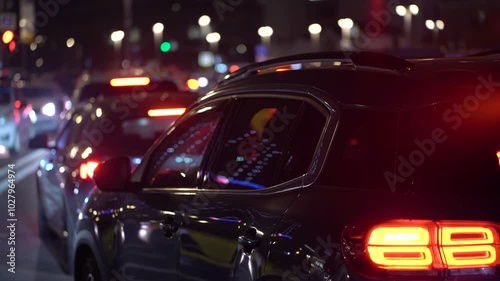 Wallpaper Mural A lot of unrecognizable cars with red brake lights are in a city traffic in the night metropolis. Multicolored bokeh of lights, glare and reflections of urban lighting road. Torontodigital.ca