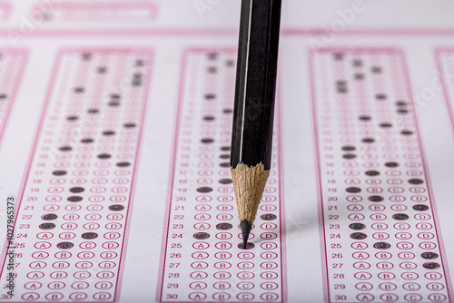 Exam, a hand taking an exam with a pen on an optical reader. Exam, an idea concept. Anxiety about the future, uncertainty. Multiple choice exam. Adults taking an exam. photo