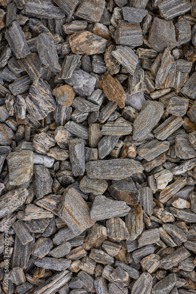 Close-up of grey and brown textured rocks forming a natural surface background. Concept of geology, earth materials, construction, and nature patterns Close-up of grey and brown textured rocks forming a natural surface background. Concept of geology, earth materials, construction, and nature patterns
