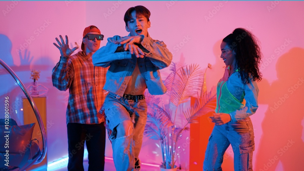 Fototapeta premium Attractive asian dancer with casual cloth dancing and looking at friend cheering him. Caucasian man and hispanic hipster perform street dancing while turn around and looking at happy team. Regalement.