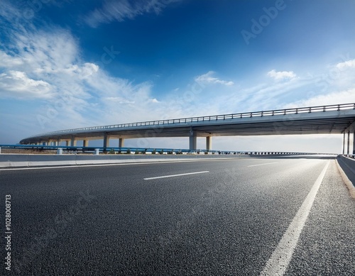 asphalt highway and bridge under blue sky