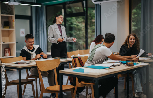 Students actively participate in a classroom setting, engaging in discussion and learning activities with peers and a teacher, showcasing an interactive academic environment.