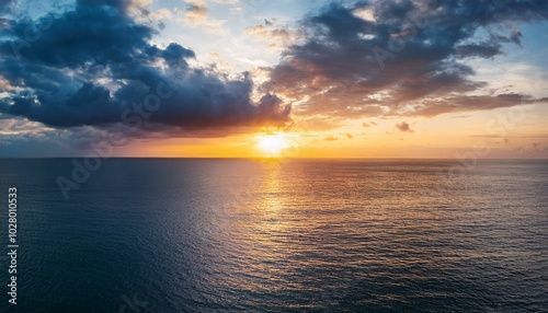 dramatic sunset and cloudy sky sea calm sea with cloudy sky through the clouds over sunset ocean and cloudy sky background tranquil seascape horizon over the sunset sea water calm cloudy sky