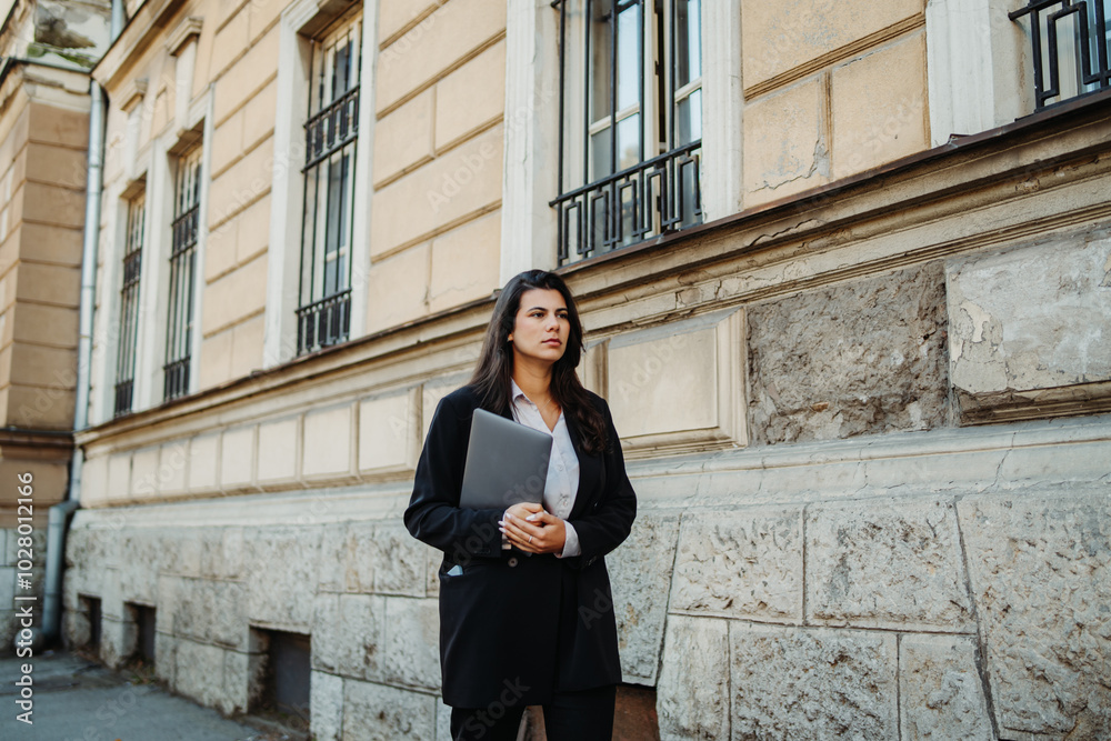 Young businesswoman going to work with laptop in the morning Young businesswoman going to work with laptop in the morning