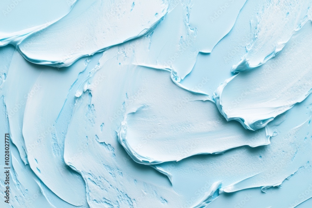 Smooth cream texture smeared across a pastel blue background showcasing a tranquil cosmetic aesthetic Smooth cream texture smeared across a pastel blue background showcasing a tranquil cosmetic aesthetic