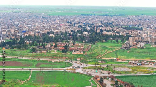 This aerial footage of Qamishli, Syria, captures houses, streets, and daily life, offering a glimpse into the city’s reality. Ideal for projects on urban life or Middle Eastern communities. photo