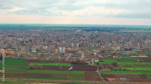 This aerial footage of Qamishli, Syria, captures houses, streets, and daily life, offering a glimpse into the city’s reality. Ideal for projects on urban life or Middle Eastern communities. photo