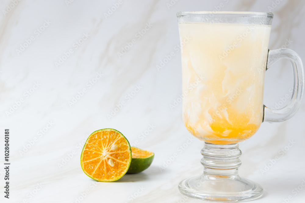 Es Kelapa Jeruk, a typical Indonesian drink made from fresh oranges squeezed with grated young coconut. with copy space. perfect for recipe, article, catalogue, or any commercial purposes. Es Kelapa Jeruk, a typical Indonesian drink made from fresh oranges squeezed with grated young coconut. with copy space. perfect for recipe, article, catalogue, or any commercial purposes.