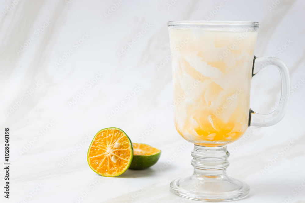 Es Kelapa Jeruk, a typical Indonesian drink made from fresh oranges squeezed with grated young coconut. with copy space. perfect for recipe, article, catalogue, or any commercial purposes. Es Kelapa Jeruk, a typical Indonesian drink made from fresh oranges squeezed with grated young coconut. with copy space. perfect for recipe, article, catalogue, or any commercial purposes.