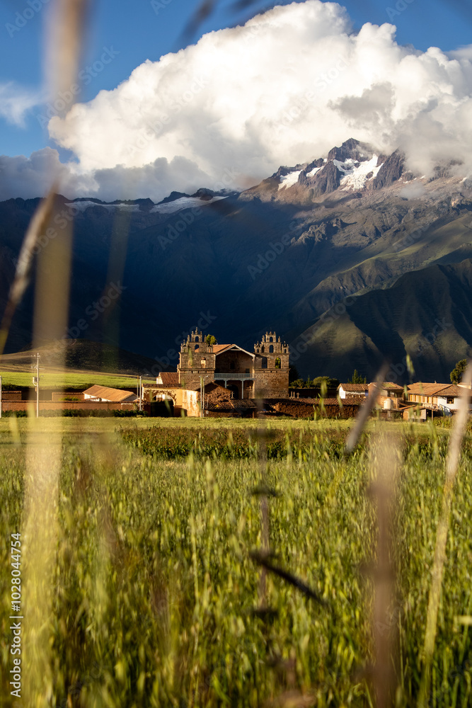 Obraz premium view of the church of tiobamba and the mountains among the grasslands