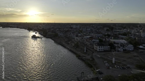 Wallpaper Mural Drone flies into sunset over Suriname River along downtown in Paramaribo, Suriname Torontodigital.ca